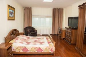 a hotel room with a bed and a television at SEVER 555 in Astana