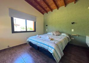 a bedroom with a bed in a room with a window at Complejo La Dorada in Merlo +49 photos