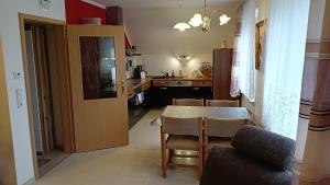 a kitchen and dining room with a table and chairs at Ferienwohnung Schwedt Kastanienhöfe in Schwedt