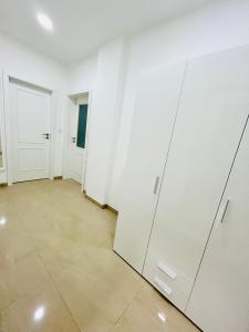 an empty room with white walls and white doors at Helen Homestay 50m from Wenceslas Square in Prague