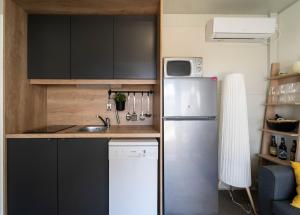 a small kitchen with a refrigerator and a sink at Mobile home Mariola in Sveti Petar