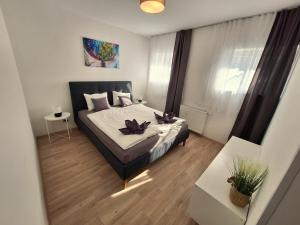 a bedroom with a bed with two candles on it at Flataid Apartments Ludersdorf - voll ausgestattet mit Parkplatz 