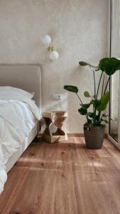 a bedroom with a bed and a potted plant at Atrium Apartments Aachen in Aachen