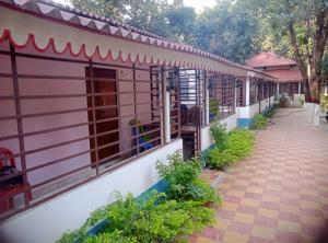 einen seitlichen Blick auf ein Haus mit Gehweg in der Unterkunft Basundhara Resort Cum Family Restaurant in Kharagpur