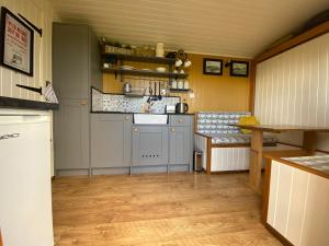 a kitchen with a sink and a counter top at Shepherds Hut in the Hills - Nr. Mold in Nannerch