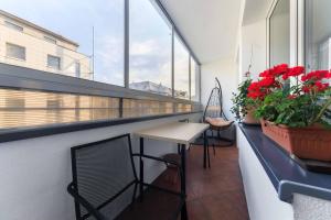 einen Balkon mit einem Tisch und einigen Blumen darauf in der Unterkunft Apartament w sercu Katowic in Kattowitz
