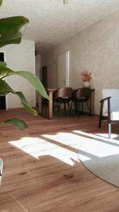 a living room with a table and chairs at Atrium Apartments Aachen in Aachen