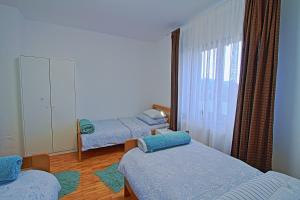 a bedroom with two beds and a mirror at Holiday Home Sinac in Sinac
