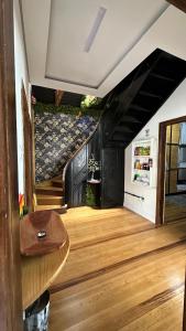 a living room with a staircase and a couch at Hostel Hug Brasil in Curitiba