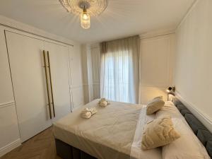 a bedroom with a bed with two stuffed animals on it at Luxury Cathedral Views in Seville in Seville