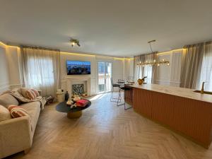 a kitchen and living room with a couch and a table at Luxury Cathedral Views in Seville in Seville