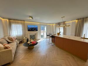 a kitchen and living room with a couch and a table at Luxury Cathedral Views in Seville in Seville