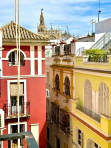 a group of buildings with a cathedral in the background at Luxury Cathedral Views in Seville in Seville
