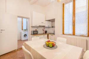 - une cuisine avec une table et un bol de fruits dans l'établissement Appartamento zona Centro-Pomposa WiFi&Netflix, à Modène