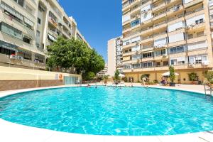 a large swimming pool in front of some buildings at VER855 - Playa y Centrico, Wifi, Fire Stick, Vistas al mar in Torremolinos
