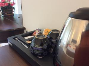 a coffee maker with two vases on a table at Lemazone Inn in Mirissa
