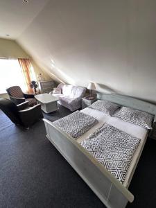 a bedroom with a large bed and a couch and a couch at Willa Wicko - Międzyzdroje - apartamenty z aneksem - widok na Zalew Szczeciński in Międzyzdroje