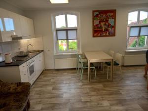 a kitchen and dining room with a table and chairs at Twój Dom in Mrągowo