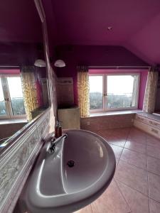a bathroom with a large tub in a purple room at Willa Wicko - Międzyzdroje - apartamenty z aneksem - widok na Zalew Szczeciński in Międzyzdroje