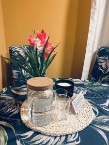 a table with a vase with a flower on it at Unique Mailo cottage in Rīga