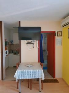 a table in a room with a kitchen and a door at Animari Apartments in Stari Grad