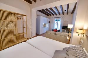 a room with a bed and a living room at Casa Rural Sierra Morena in Cazalla de la Sierra