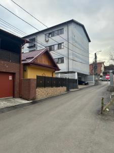 an empty street with a building and a house at Apartament Chloe in Tulcea