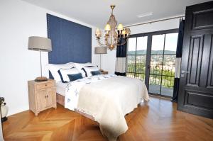 a bedroom with a bed and a chandelier at Riviera Living in Mandelieu-la-Napoule