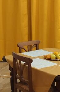 a table with two chairs and a plate of fruit at Studio Rocha Carvoeiro- Open Space in Carvoeiro +7 photos