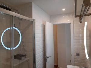 a bathroom with a glass shower with a mirror at Apartamento Playa Paseo Marítimo Almería in Almería