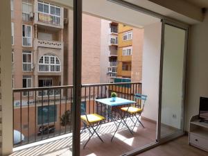a balcony with a table and chairs in a apartment at Apartamento Playa Paseo Marítimo Almería in Almería