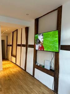 a living room with a flat screen tv on a wall at Wohnung in Weilburg am Schloss in Weilburg