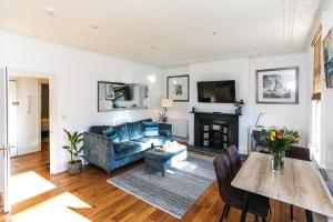 a living room with a couch and a table at Newbridge Road, One bedroom Apartment in Bath
