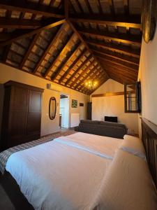 a bedroom with a large white bed in a room at Posada Alegria in Medina Sidonia