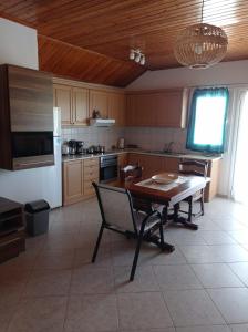 a kitchen with a table and chairs and a refrigerator at Acheron rooms in Preveza