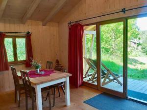 a dining room with a table and a sliding glass door at Dengler Hof in Hohenberg an der Eger