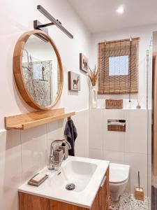 a bathroom with a sink and a mirror at Chaty w chmurach in Komańcza
