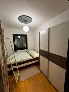 a small bedroom with a bed and a mirror at Wohnung mitten im Salzkammergut in Ohlsdorf