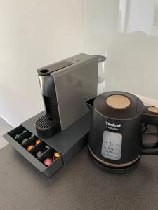 a coffee maker and a slow cooker next to a coffee pot at Napsugár Vendégház in Zánka