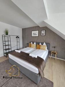 a bedroom with a large bed in a room at Bird Home Room 15 in Klagenfurt