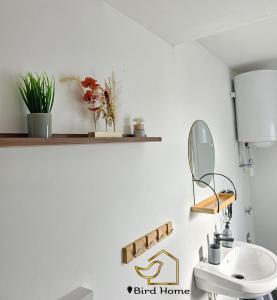 a bathroom with a sink and a mirror at Bird Home Room 15 in Klagenfurt