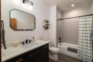 a bathroom with a sink and a toilet and a mirror at Moonlight Lodge, luxury home, Zion and Bryce in Orderville +16 photos