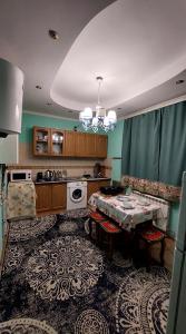 a kitchen with a table in the middle of it at Коттеджный городок Чапаевка, Голосеевкий район in Kyiv