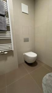 a white bathroom with a toilet and a window at AR ALBELLI HOUSE II in Košice +17 photos