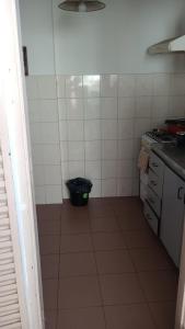 a kitchen with a black trash can in a room at La paz in Buenos Aires