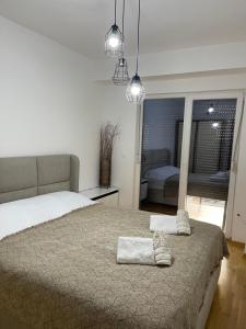 a bedroom with a bed with two towels on it at Diamond Apartment in Strumica