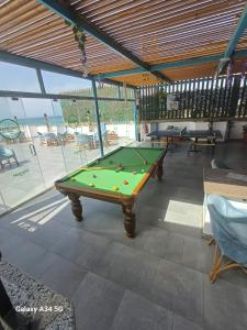 a pool table in a room with a view of the beach at Palm Inn City Hotel in Hurghada