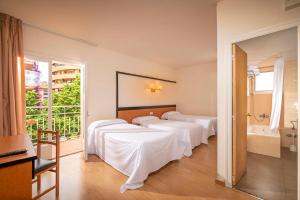 a hotel room with four beds and a bathroom at The BB Hotel Boutique Can Colom in Lloret de Mar