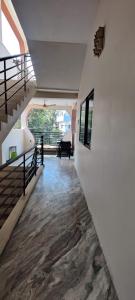 a hallway with stairs and a piano in a house at Blissful Nest Homestay in Ujjain