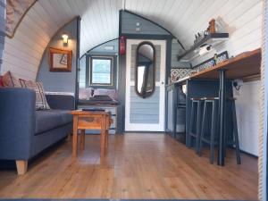 a living room with a couch and a table at Etive Pod, West Highland Way Holidays in Kinlochleven